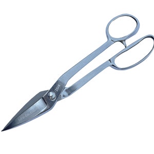 May include: Silver metal shears with a pointed blade and two handles. The shears have a small round label with the text "IDS" on the handle.