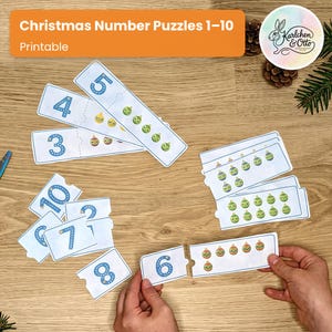May include: Christmas Number Puzzles 1-10 Printable set featuring rectangular cards with blue numbers and corresponding counts of colorful Christmas ornament illustrations. Each card is designed as a two-piece puzzle to match the digit to the quantity.