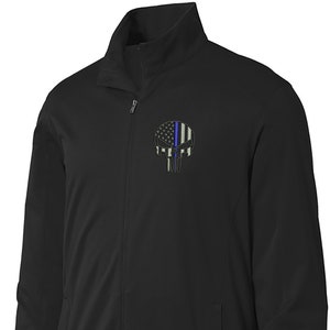 May include: Black zippered jacket with a  Punisher skull graphic featuring an American flag with a blue line down the center.