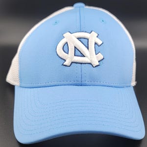 May include: A light blue baseball cap with a white mesh back and a white embroidered "NC" logo.