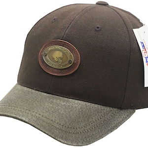 May include: A brown baseball cap with a brown leather patch that says "Cleveland Browns Football" and a brown and green camouflage brim.