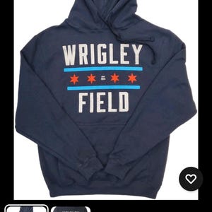 May include: Navy blue hooded sweatshirt with the text "WRIGLEY FIELD" in white and red lettering. The design includes red stars and blue stripes. A comfortable, casual top.