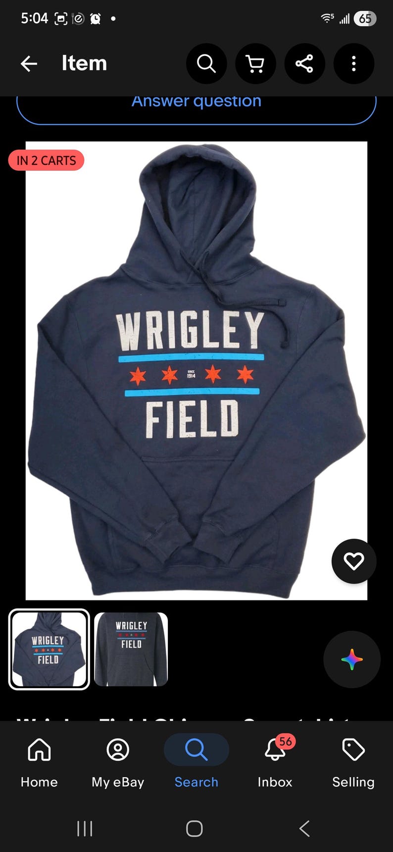 May include: Navy blue hooded sweatshirt with the text "WRIGLEY FIELD" in white and red lettering. The design includes red stars and blue stripes. A comfortable, casual top.