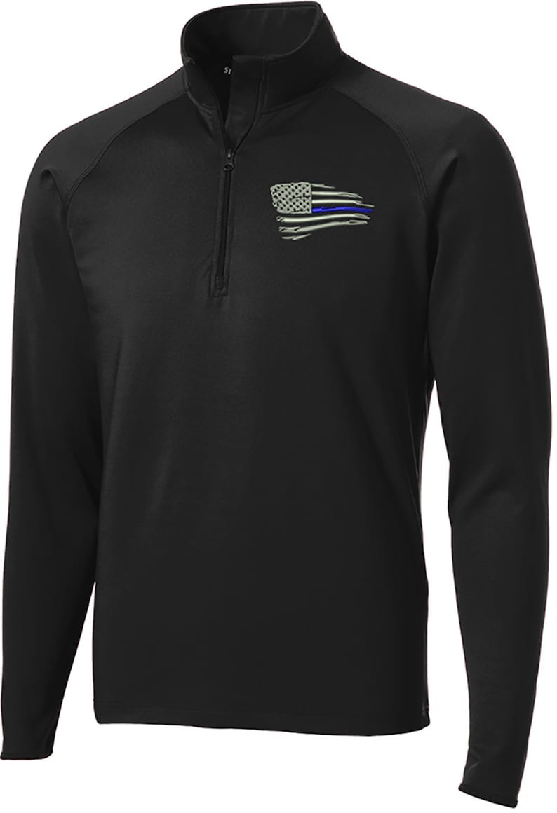 May include: Black long-sleeve performance shirt with a quarter-zip closure. The shirt features a distressed American flag with a blue line running through it.