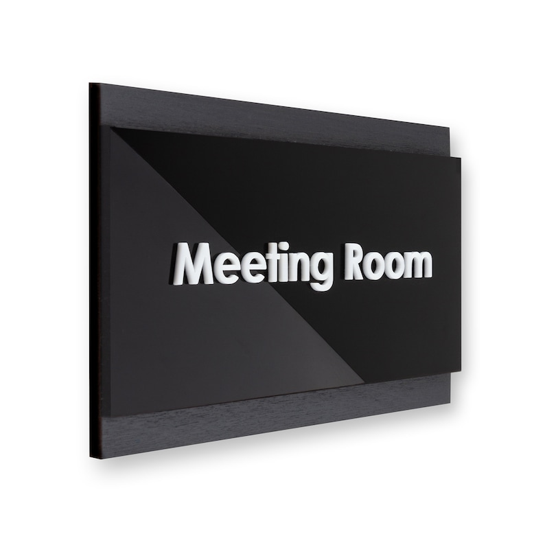 May include: Black sign with a wood frame and the text "Meeting Room" in white raised letters.