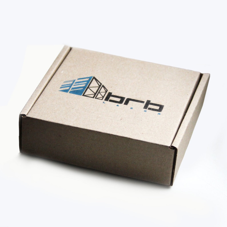 May include: A brown cardboard box with a logo printed on the top. The logo is a stylized building with the text "brb" below it.