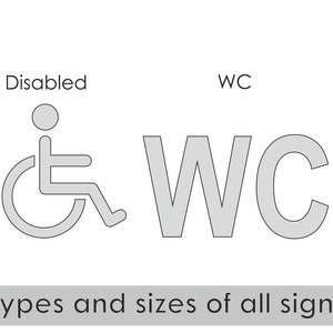 May include: A set of five gray restroom signs with pictograms for men, women, disabled, WC, and mother and child. The signs are 3.5 inches tall and 90 mm wide. The text "Types and sizes of all signs" is below the signs.