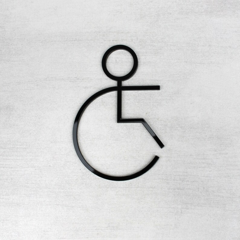 May include: Black and white accessibility symbol, depicting a person in a wheelchair.