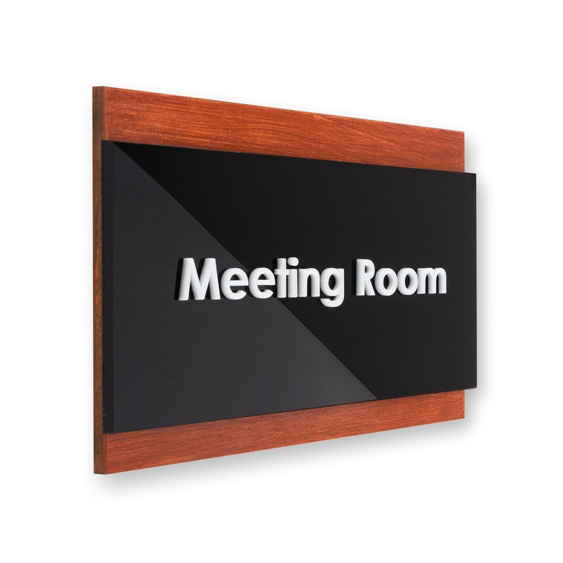 May include: A wooden framed sign with a black background and white lettering that reads "Meeting Room".