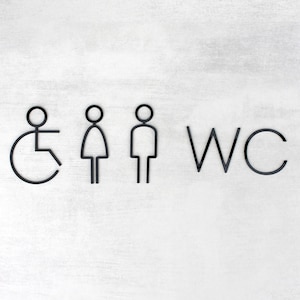 May include: Black and white WC sign with symbols for men, women, and wheelchair accessibility.