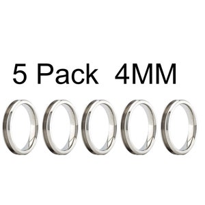 May include: Five silver-colored rings, each 4mm wide, are displayed in a row against a white background. The rings have a simple, polished design. The text "5 Pack 4MM" is above the rings.
