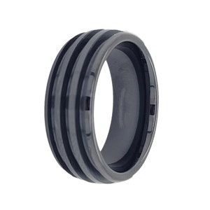 May include: A black and silver ring with a grooved design. The ring has a polished finish and a comfortable fit.