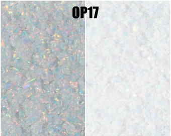 May include: Close-up image of iridescent white opal chips, showing the difference between wet and dry. The opal chips are wet on the left side of the image and dry on the right side. The text "OP17" is at the top of the image. The text "Wet" is below the wet opal chips and the text "Dry" is below the dry opal chips. The text "Pictures are Property of OpalandFindings.com All Rights Reserved" is at the bottom of the image. The text "OPAL & findings" is at the bottom right of the image.