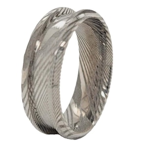 May include: A silver ring with a unique, swirling, textured pattern. The ring is made of metal and has a polished finish.