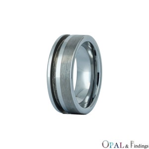 May include: A silver tungsten carbide ring with a brushed finish and a grooved accent band.