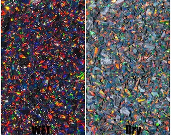 May include: A close-up image of black opal chips, showing the difference in colour and iridescence when wet and dry. The text "OP 90" is visible in the top right corner of the image. The text "WET" is visible in the bottom left corner of the image. The text "DRY" is visible in the bottom right corner of the image. The text "OPAL & findings" is visible in the bottom right corner of the image.