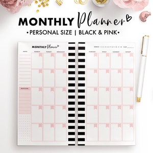 May include: A black and pink monthly planner with a pink heart and the text "MONTHLY Planner" on the cover. The planner has a black and white striped binding.