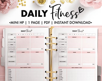 May include: A pink and white daily fitness planner with a gold binder. The planner has sections for sleep, mood, water, vitamins, steps, total calories, breakfast, lunch, dinner, snacks, and today's workout/notes.