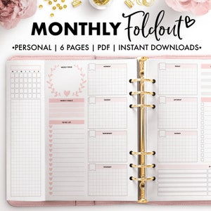 May include: A pink planner with gold accents, open to a weekly spread. The planner features a grid layout with sections for each day, weekly goals, and a to-do list. The text "MONTHLY Foldout" is at the top.