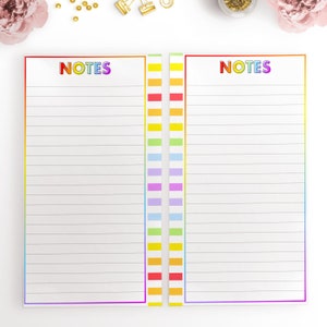 May include: Two blank lined pages with the word "NOTES" in rainbow letters at the top of each page. The pages are bordered with a rainbow stripe.