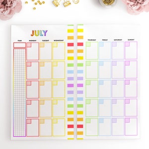 May include: A printable July calendar with rainbow colored borders. The calendar is divided into seven columns for each day of the week, with a separate column for the year. Each day has a box for writing in appointments or events.