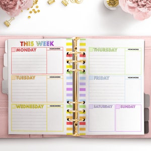 May include: A weekly planner with a rainbow color scheme. The planner has a tab for each day of the week: Monday, Tuesday, Wednesday, Thursday, Friday, Saturday, and Sunday. Each day has a space for homework.