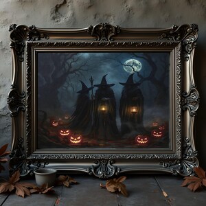 May include: A framed wall art piece featuring three figures in dark cloaks and pointed hats standing in a misty forest under a full moon. The figures hold glowing lanterns, surrounded by several illuminated jack-o'-lanterns on the ground.