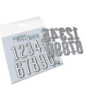 May include: A set of ten metal number dies for crafting. The dies are silver and feature the numbers 1 through 0. The dies are packaged in a clear plastic bag with a white header that reads "Karten Kunst Dies".