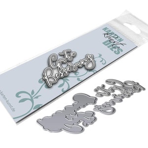 May include: Two metal die-cut stencils for crafting. The larger stencil says "Gute Besserung" in a cursive font. The smaller stencil says "Happy Birthday" in a cursive font.