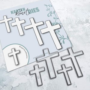 May include: A set of five metal cross-shaped dies for crafting. The dies are arranged in a staggered pattern, with the largest cross at the top and the smallest cross at the bottom. The dies are made of a silver-coloured metal.