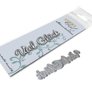 May include: A die-cutting stencil for crafting, featuring the words "Viel Glück" and "Glück gehabt" in a decorative script font. The stencil is made of metal and is packaged in a clear plastic bag.