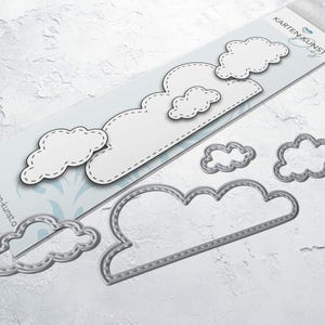 May include: A set of six metal die-cut cloud shapes with a stitched design. The clouds are in various sizes and are arranged on a white background. The largest cloud is at the bottom of the image and the smallest cloud is at the top. The text "Kartenkunst Dies" is visible in the upper right corner of the image.