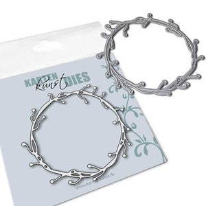 May include: Metal die cut in the shape of a wreath with a delicate, twig-like design. The die is made by "Karten Kunst" and is designed for crafting projects.