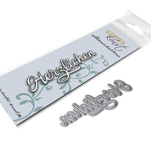 May include: Metal die cut with the words "Herzlicher" and "nachträglich" in a cursive font. The die cut is packaged in a clear plastic bag with a white card that says "Karen Rust" and "Stanzschablone".