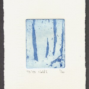 May include: A blue and white print titled "Wald I" with vertical lines within a rectangular shape. The print is on textured white paper, with the text "Ts.'09 Wald I" and the number "8/20" visible. The artwork has a minimalist aesthetic.