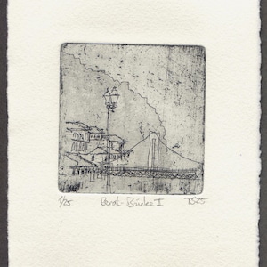May include: A black and white etching on textured paper featuring a line drawing of a bridge and a street lamp. The print is titled Berat-Brücke II, numbered 1/25, and signed TS25. The artwork depicts a structural bridge scene with architectural details.