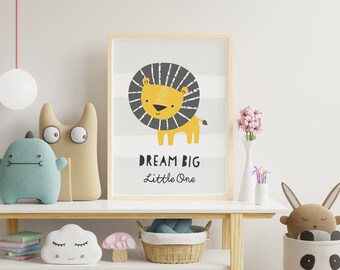 May include: A framed print with a cute cartoon lion with a black mane and the text "Dream Big Little One". The print is on a white shelf with a variety of stuffed animals and other decor.