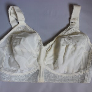 May include: A white bra with lace trim and adjustable straps.