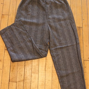 May include: Black and white patterned pants with a wide leg and an elastic waistband.