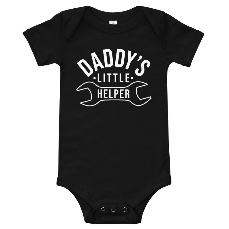 K&ouml;nnte beinhalten: Schwarzer kurz&auml;rmeliger Baby-Body mit wei&szlig;em Text "Daddy's Little Helper" und einer Schraubenschl&uuml;sselgrafik.
