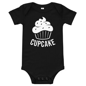 May include: Black baby onesie with a white cupcake graphic and the word "CUPCAKE" printed below it.