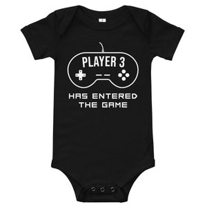 May include: Black baby onesie with a white graphic of a video game controller and the text "PLAYER 3 HAS ENTERED THE GAME".