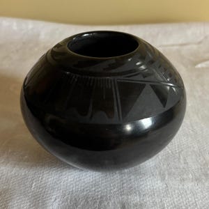 May include: A set of three ceramic mugs with a speckled, matte finish. The mugs are in shades of cream, light gray, and dark gray. Each mug has a simple, minimalist design and a rounded handle.