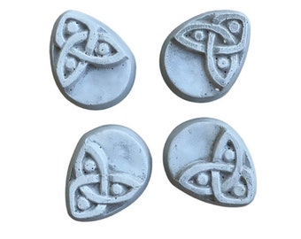 May include: Four gray stone-like coasters with a Celtic knot design. Each coaster is shaped like a teardrop.