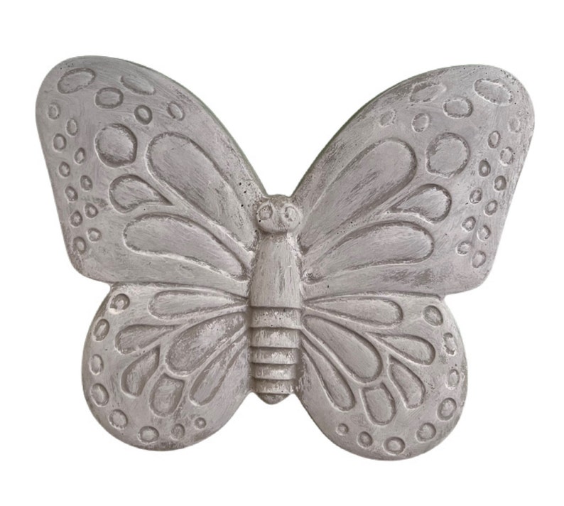 May include: A gray butterfly-shaped decorative object with detailed wing patterns and a textured surface. The butterfly has a symmetrical design with rounded wings and a central body. The object is likely made of a solid material, such as stone or concrete.