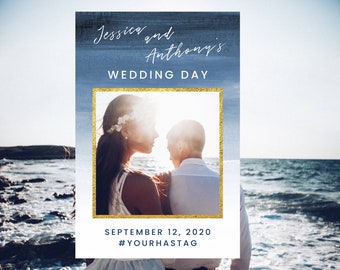May include: A wedding invitation with a blue watercolor background and a gold frame around a photo of a couple. The text reads "Jessica and Anthony's Wedding Day" and "September 12, 2020 #YOURHASTAG".