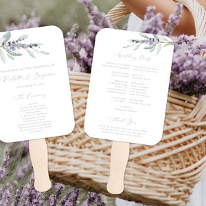 May include: Two lavender wedding ceremony fans with a watercolor design of lavender sprigs and greenery. The text on the fans reads "Welcome to the wedding of Pirlitla & Bejamen, November 27, 2021, The Ceremony" and "Wedding Party".