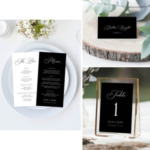 May include: Black and white wedding menu cards with calligraphy font. The bar menu card lists wine, spirits, beer and cider, and signature cocktails. The menu card lists a starter, main, dessert, and wedding cake. The cards are on a white plate.