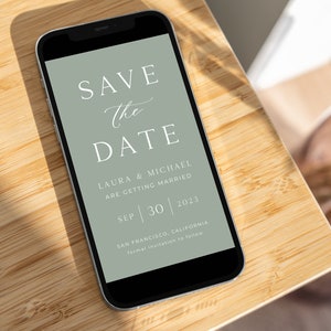 May include: A smartphone screen displaying a save the date announcement for Laura and Michael's wedding on September 30, 2023 in San Francisco, California. The announcement is on a green background with white text.