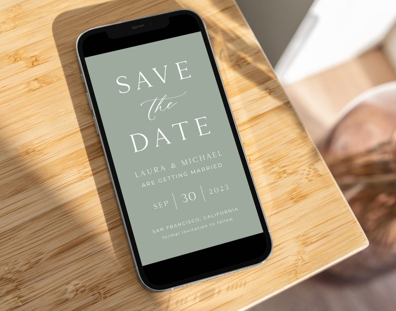 May include: A smartphone screen displaying a save the date announcement for Laura and Michael's wedding on September 30, 2023 in San Francisco, California. The announcement is on a green background with white text.
